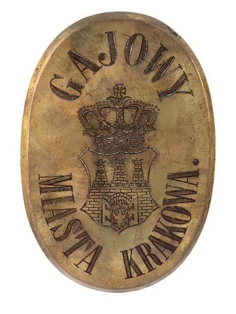 (730) Blaszana odznaka gajowego miasta Krakowa do przypinania
na czapce lub kurtce mundurowej. Prawdopodobnie
z przełomu wieków XIX i XX
(MK, nr inw. MHK 112a/III)